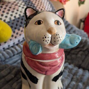 Ceramic cookie jar in the shape of a black and white cat with a fish